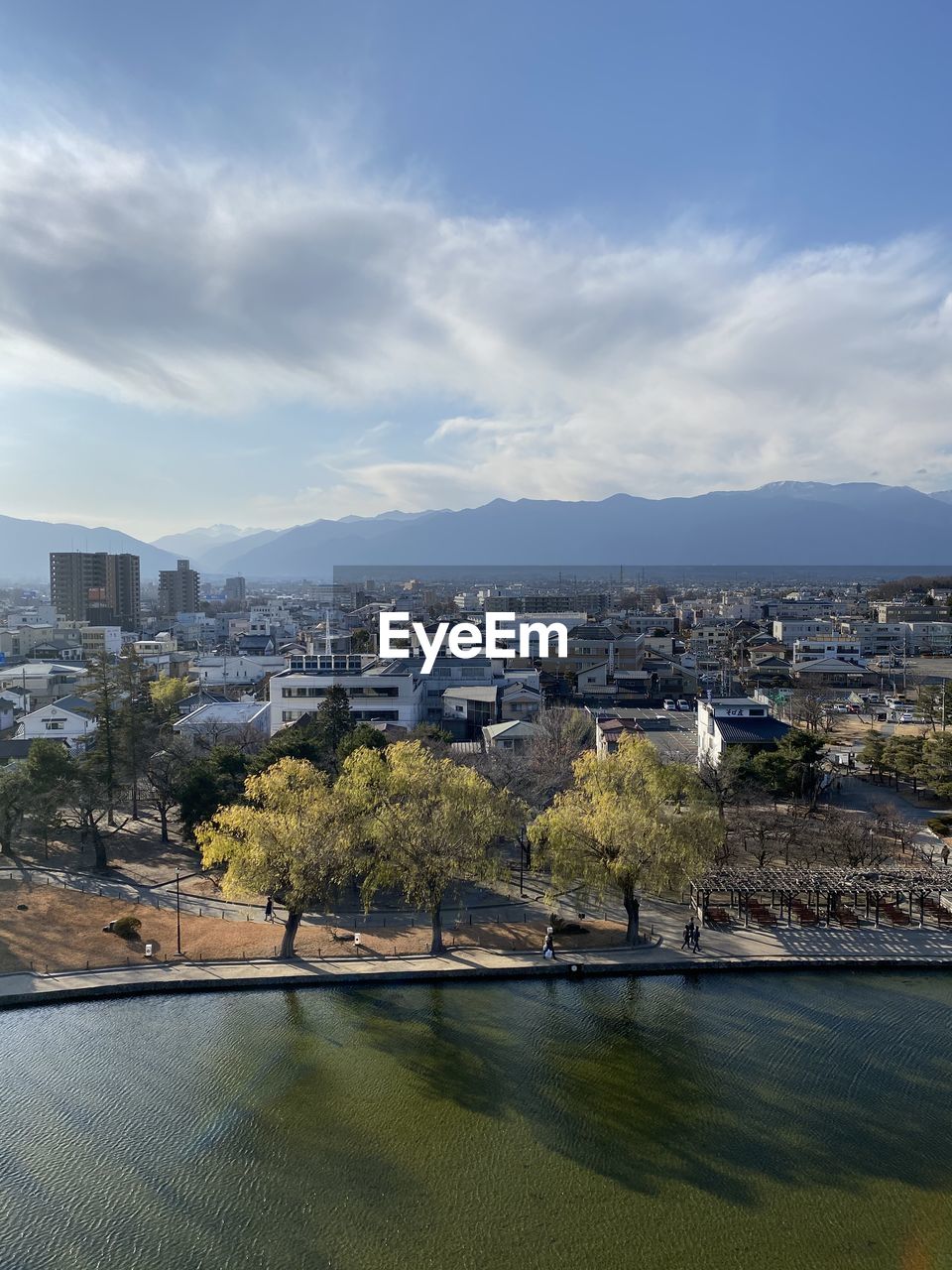 High angle view of buildings and river against sky