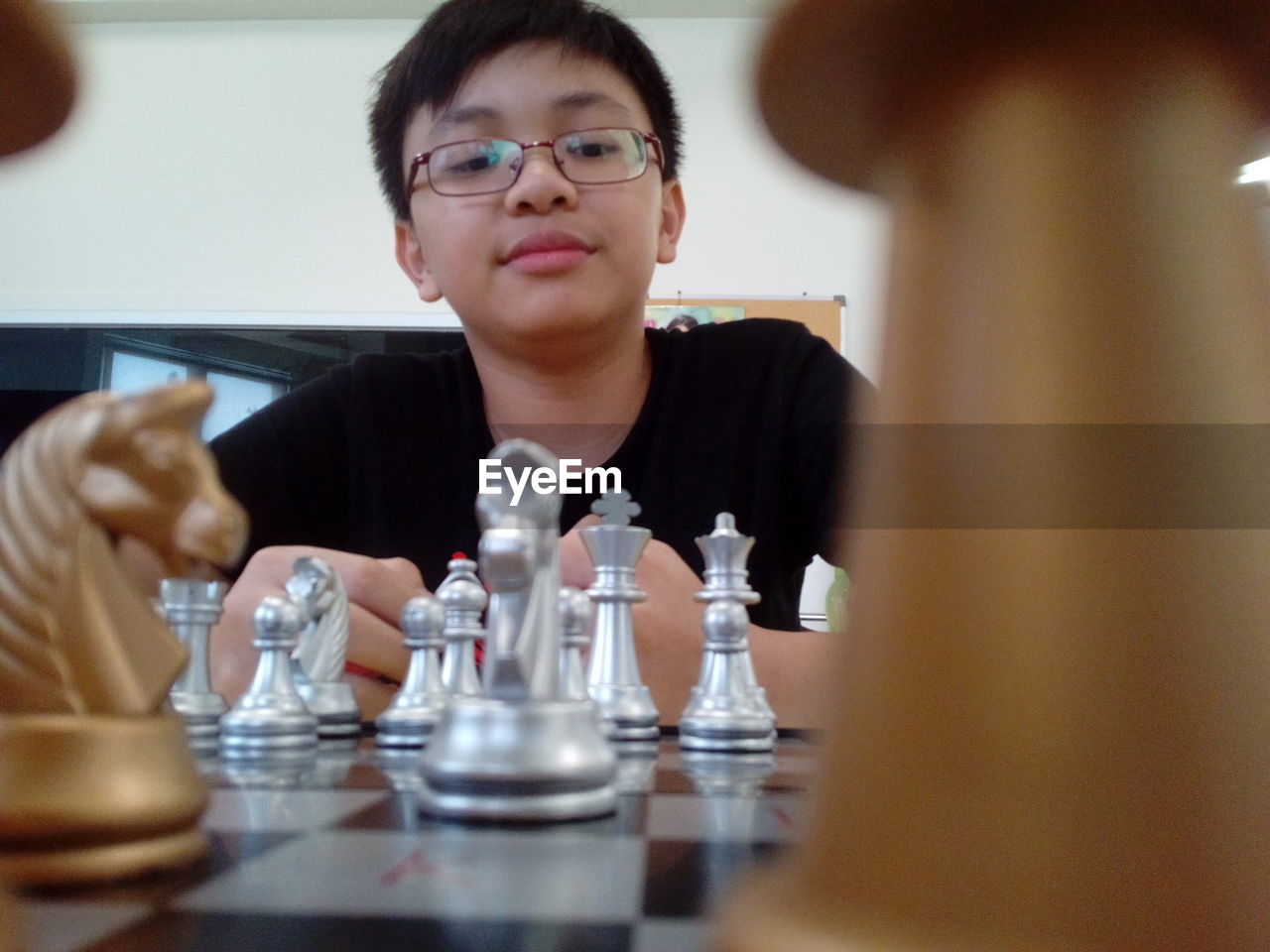 Boy playing chess during competition