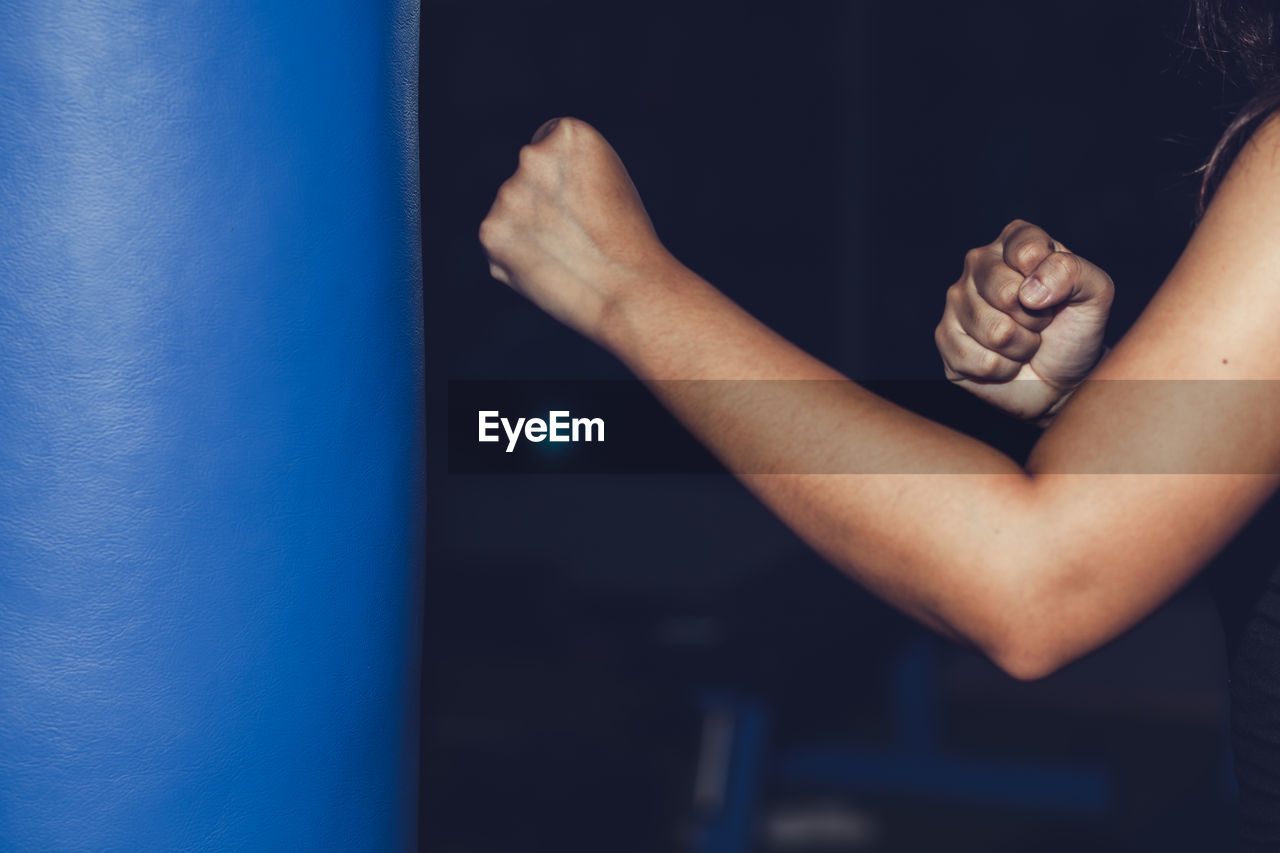 Close-up of person boxing on punching bag