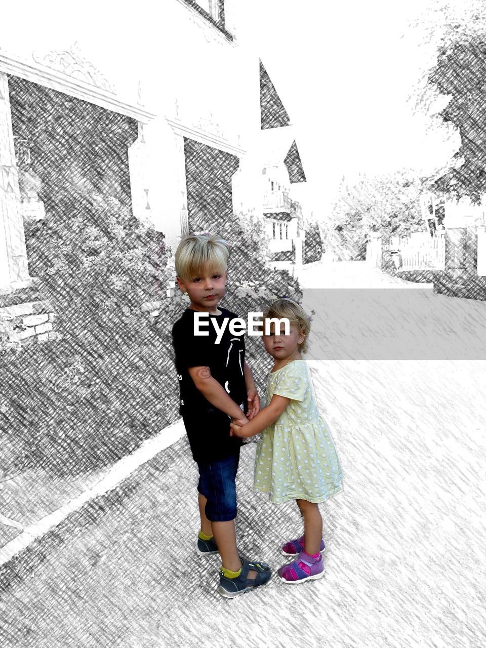 SIBLINGS PLAYING WITH SNOW