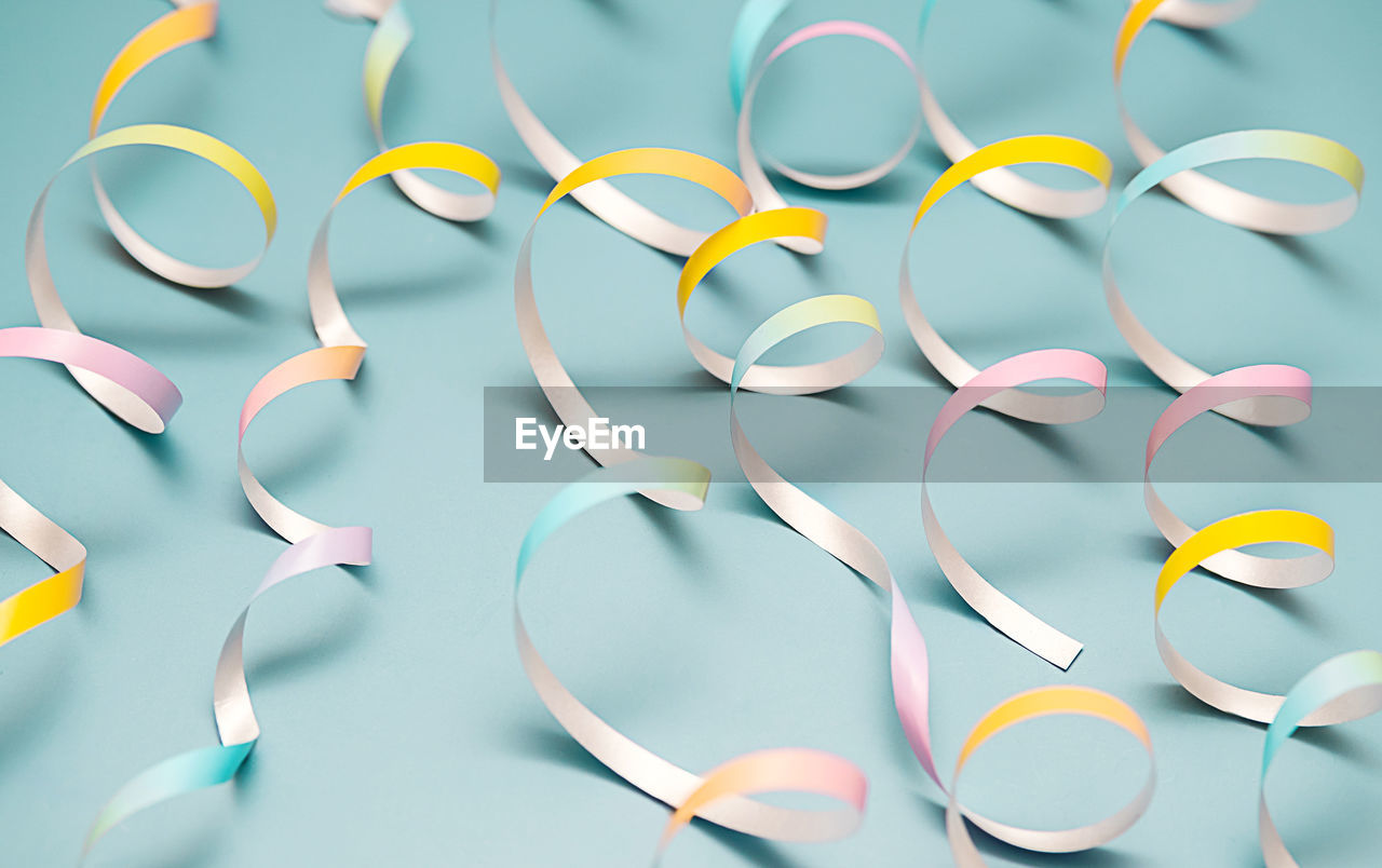 circle, no people, studio shot, indoors, font, large group of objects, multi colored, blue, still life, colored background, variation, healthcare and medicine, line, close-up, yellow, blue background
