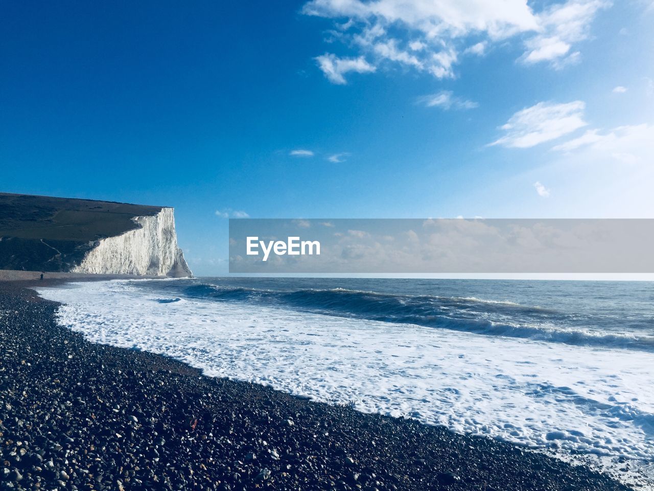 Scenic view of sea against blue sky