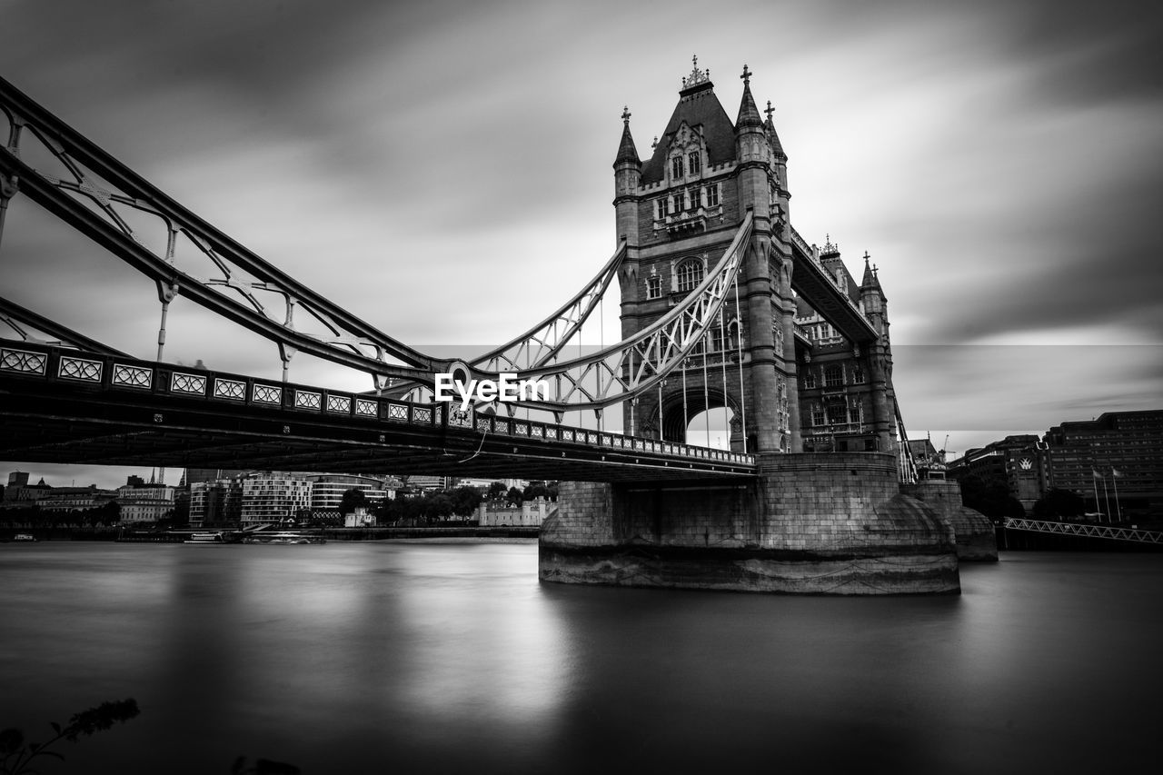 Tower bridge over thames river against sky in city