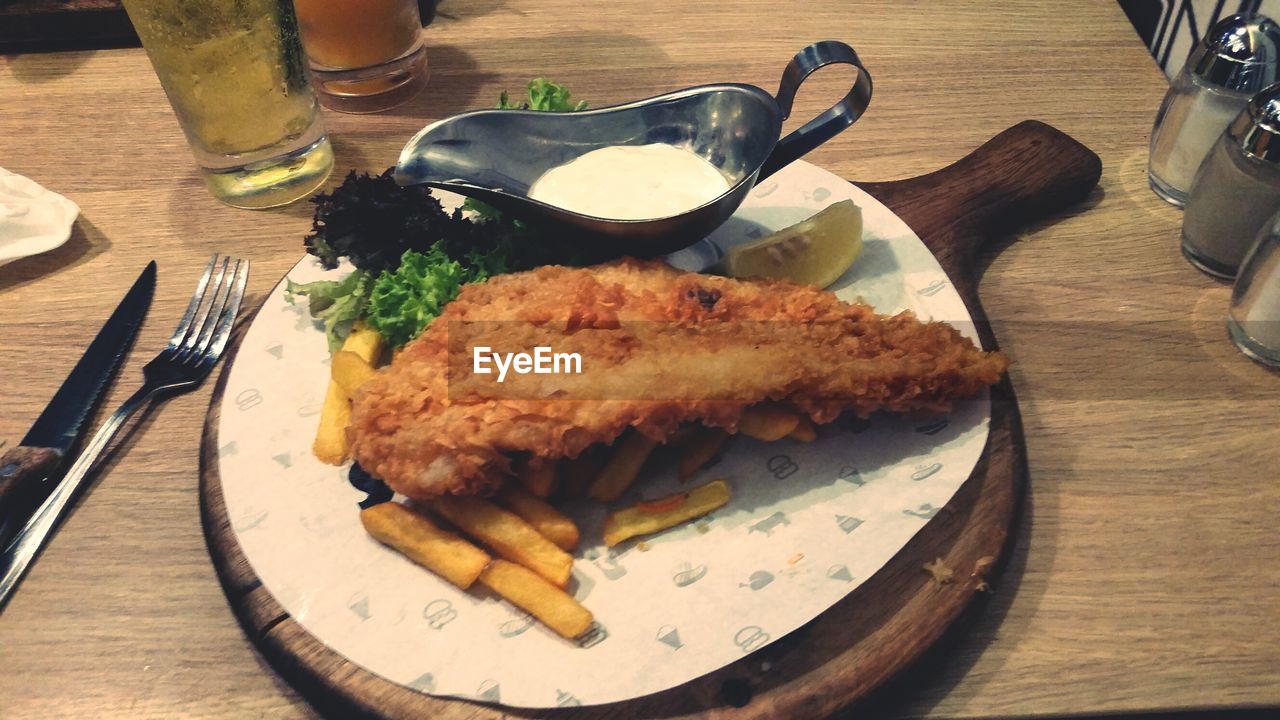 CLOSE-UP OF MEAT ON TABLE