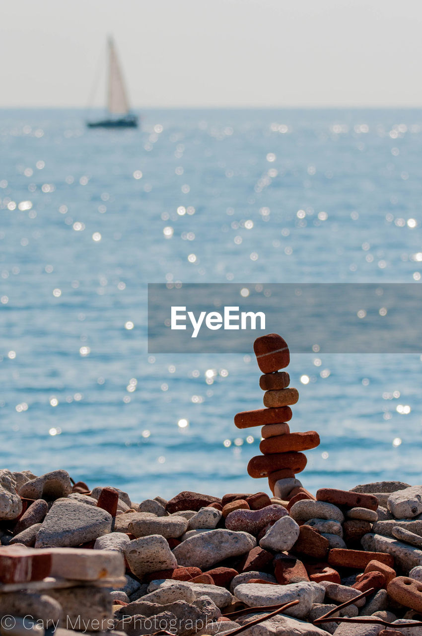 STACK OF PEBBLES ON SEA SHORE