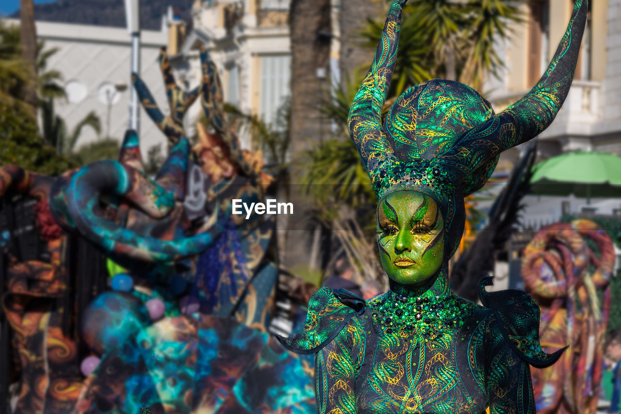 carnival, tradition, festival, disguise, celebration, mask - disguise, multi colored, mask, representation, sculpture, focus on foreground, event, creativity, dancing, day, arts culture and entertainment, human representation, costume, clothing, outdoors, craft, person, statue, architecture