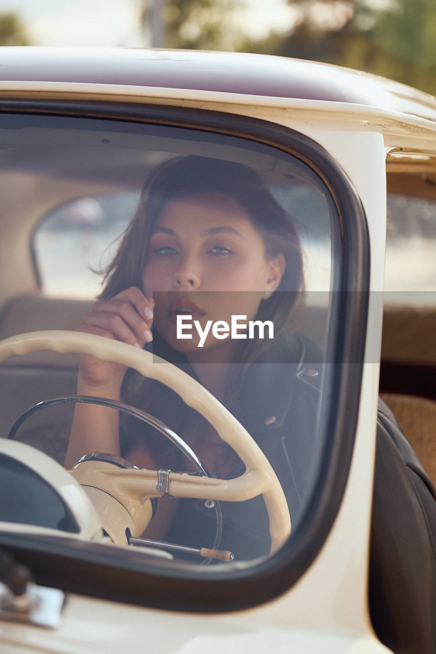 Portrait of woman sitting in car