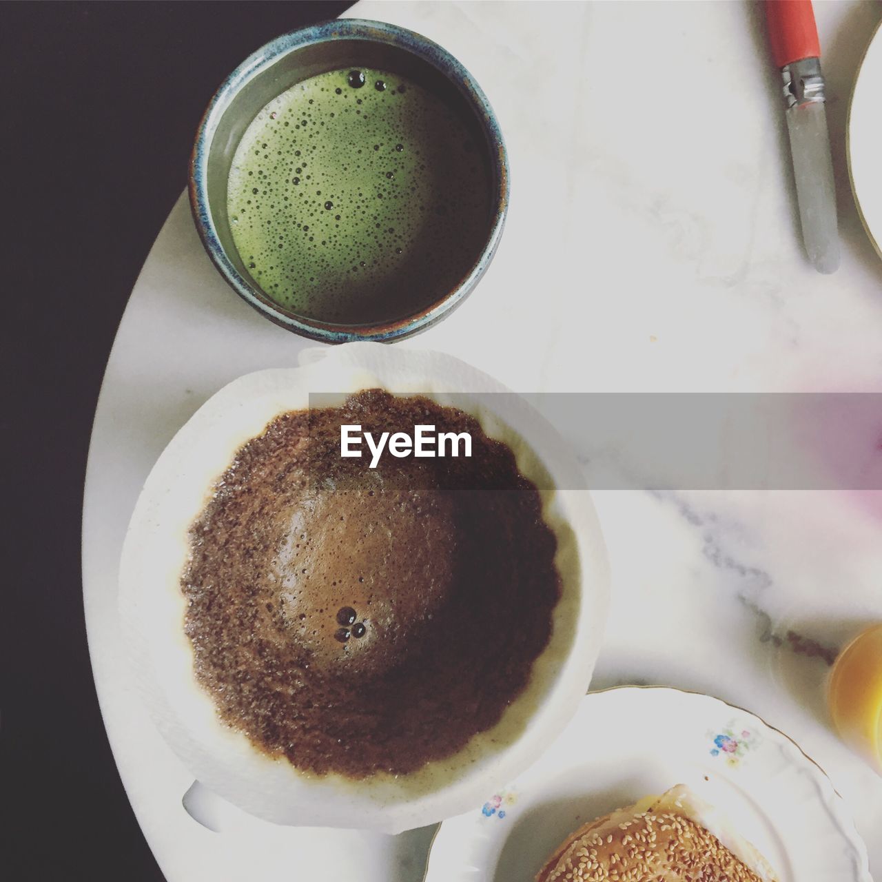 Directly above shot of coffee and matcha tea served on table