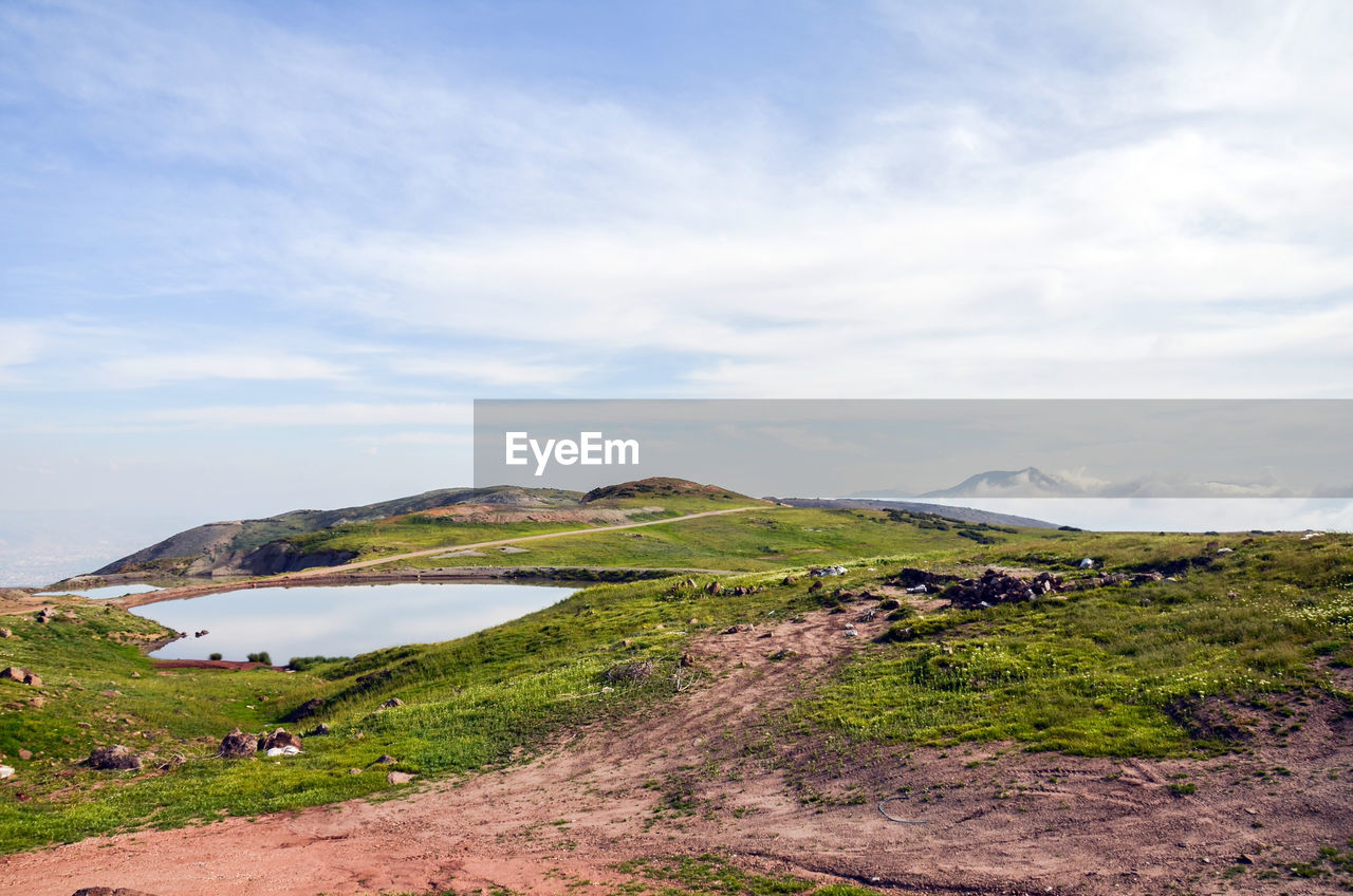 SCENIC VIEW OF LANDSCAPE AND MOUNTAINS AGAINST SKY