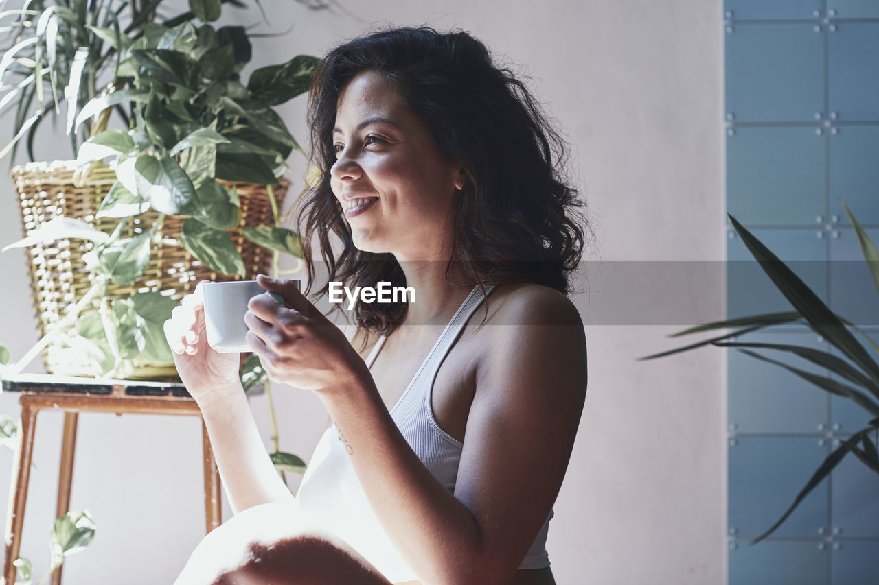 Beautiful woman drinking coffee at home