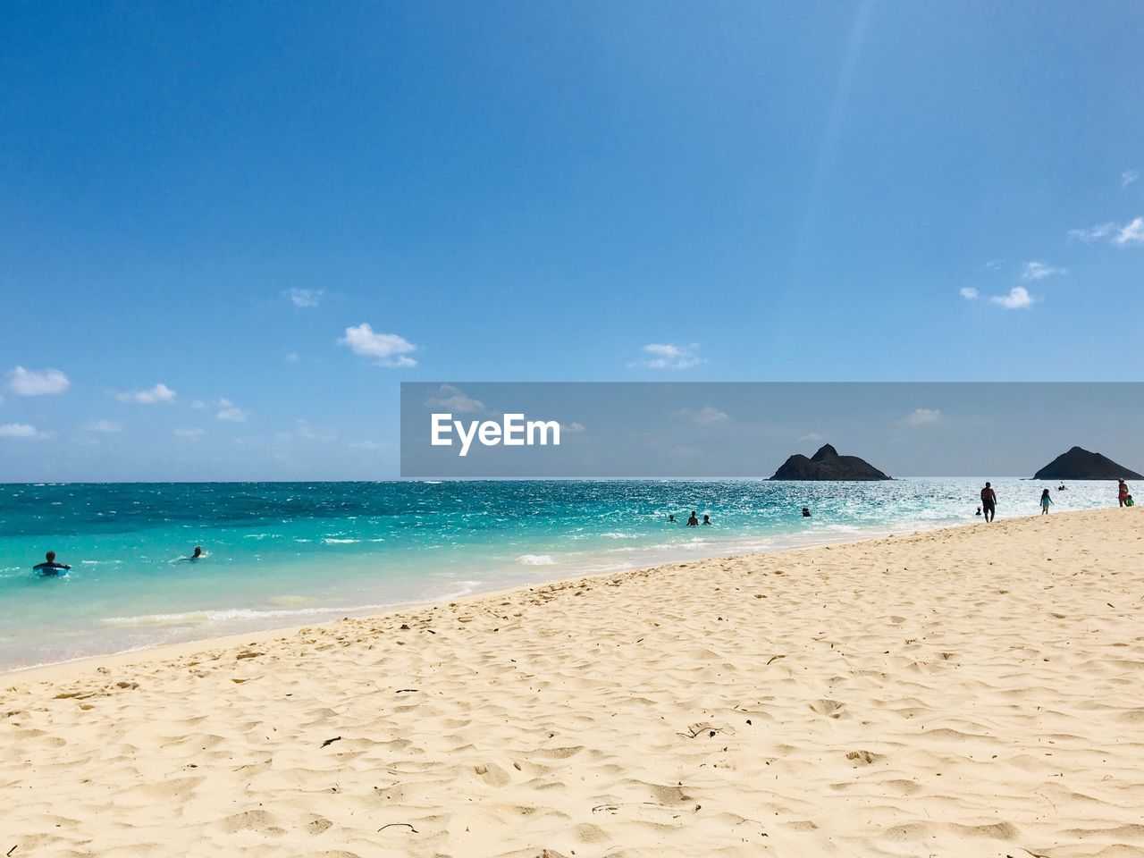 Scenic view of beach against blue sky