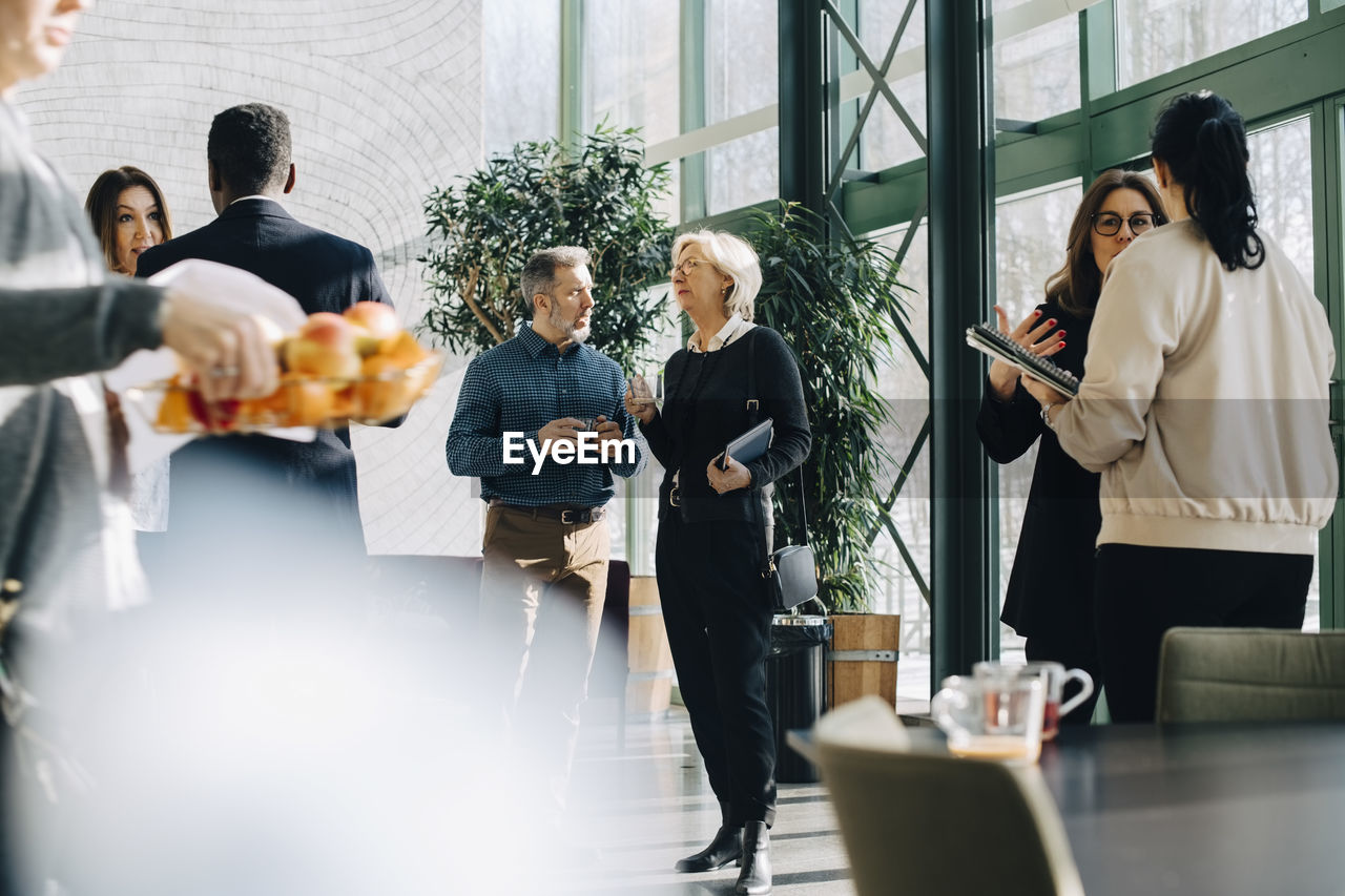 Businessmen and businesswomen planning while standing in office