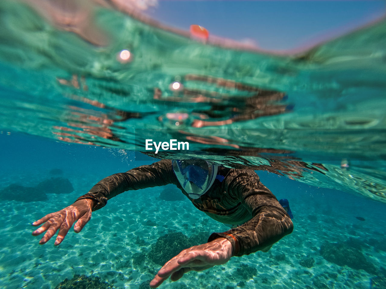 Man in mask swimming in sea 