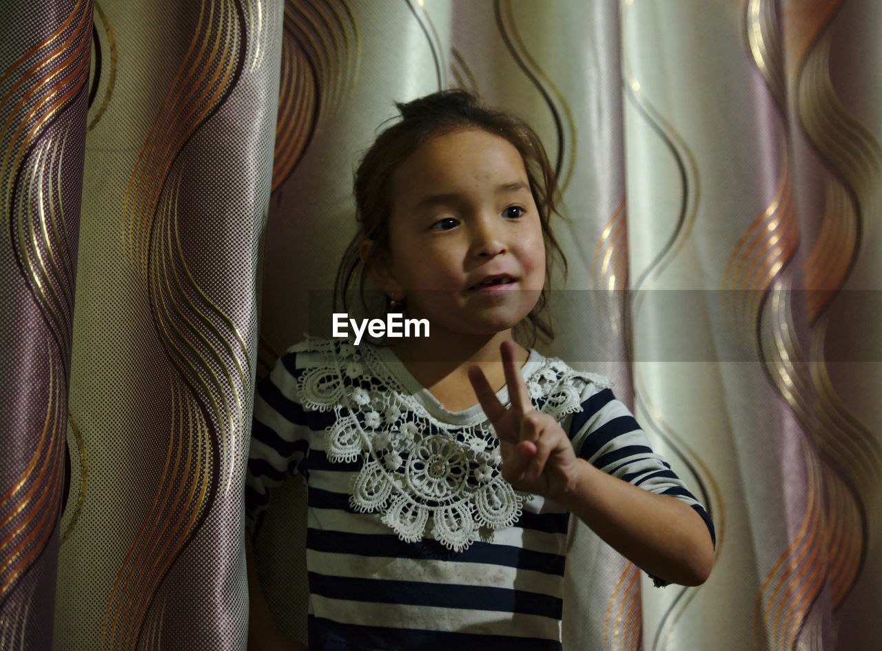 PORTRAIT OF A SMILING GIRL IN A ROOM