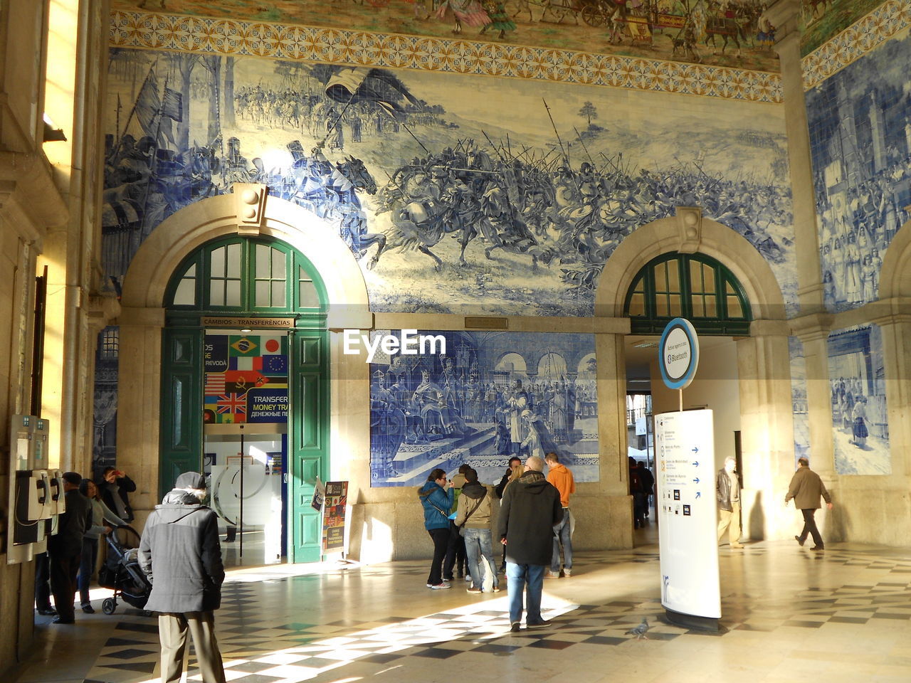 PEOPLE WALKING IN CORRIDOR OF CATHEDRAL