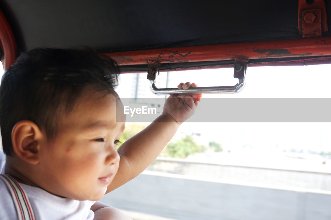 Close-up of cute baby boy in bus