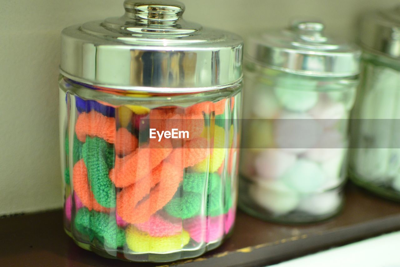Colorful rubber bands in glass container