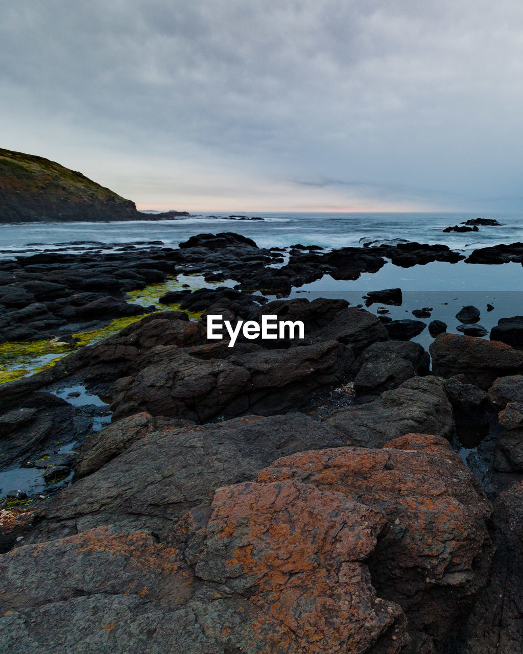 Rocks on beach against sky