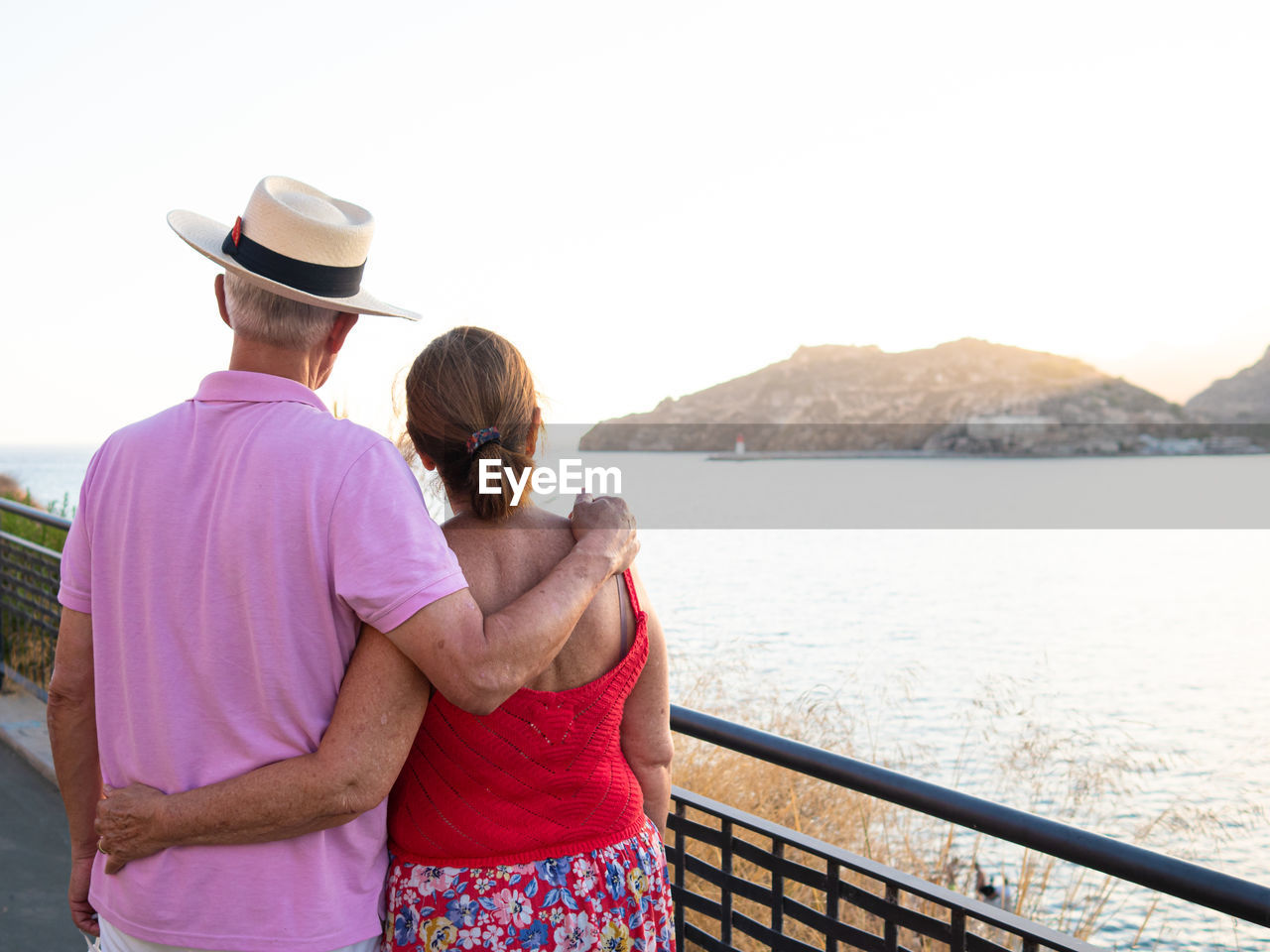 Caucasian elderly couple enjoying the scenery from a harbor lookout po