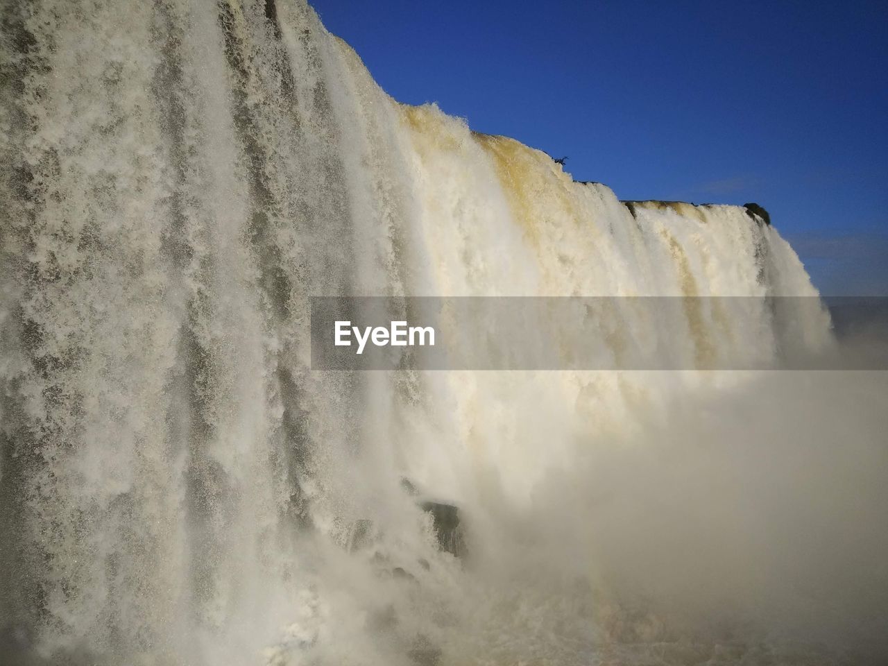 Low angle view of waterfall against sky