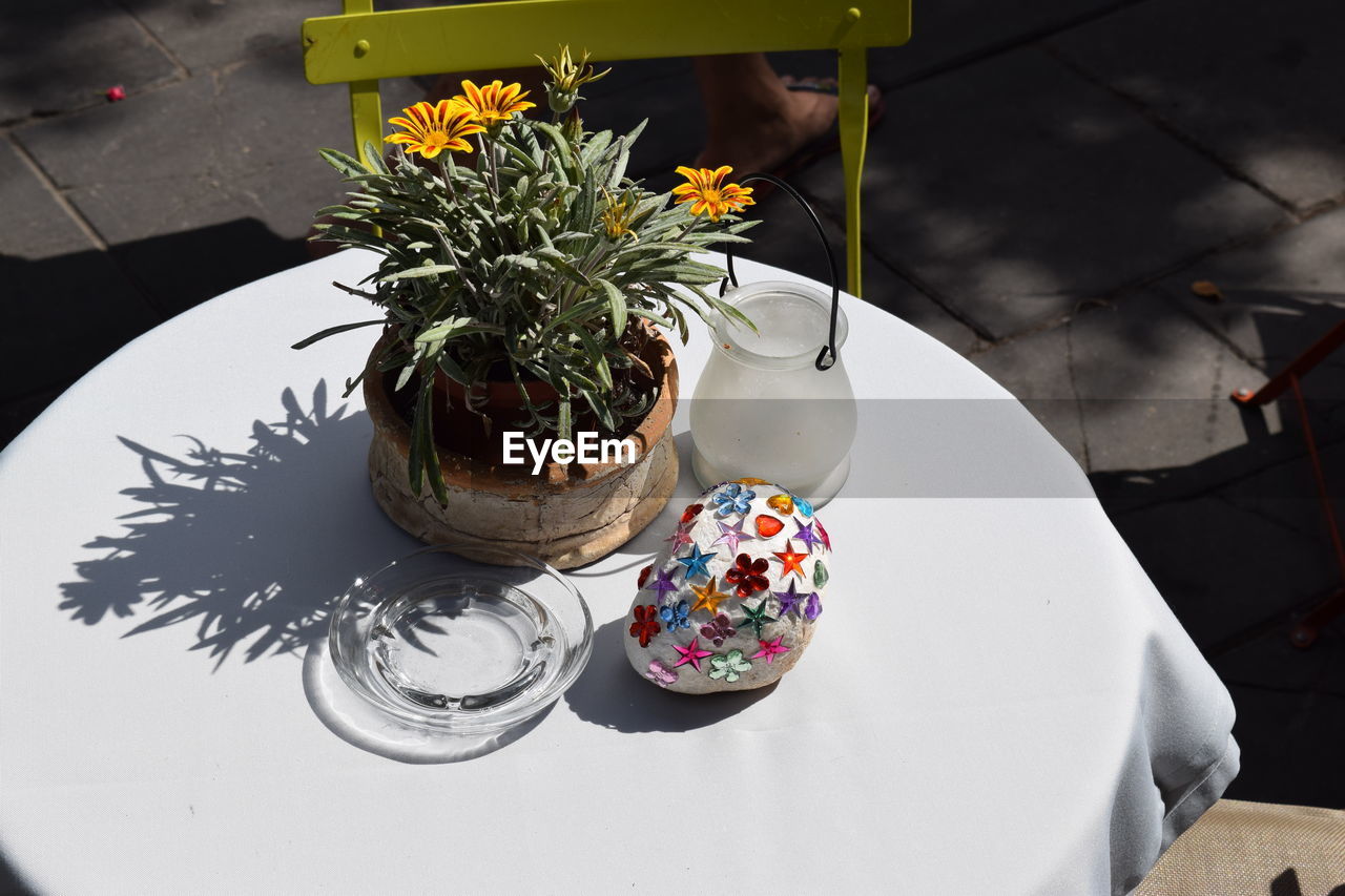 Potted plant and decorated stone on restaurant table