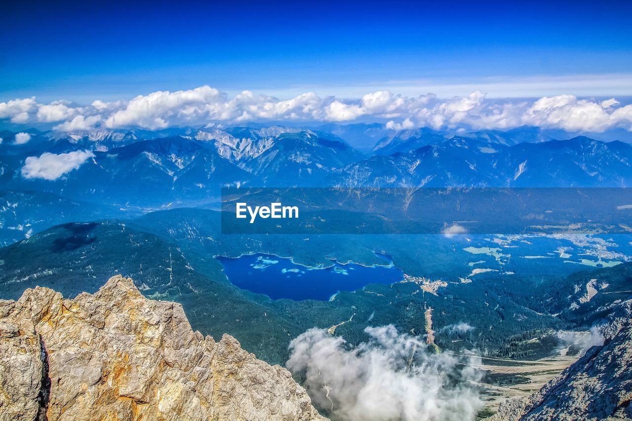 Aerial view of mountain range against cloudy sky