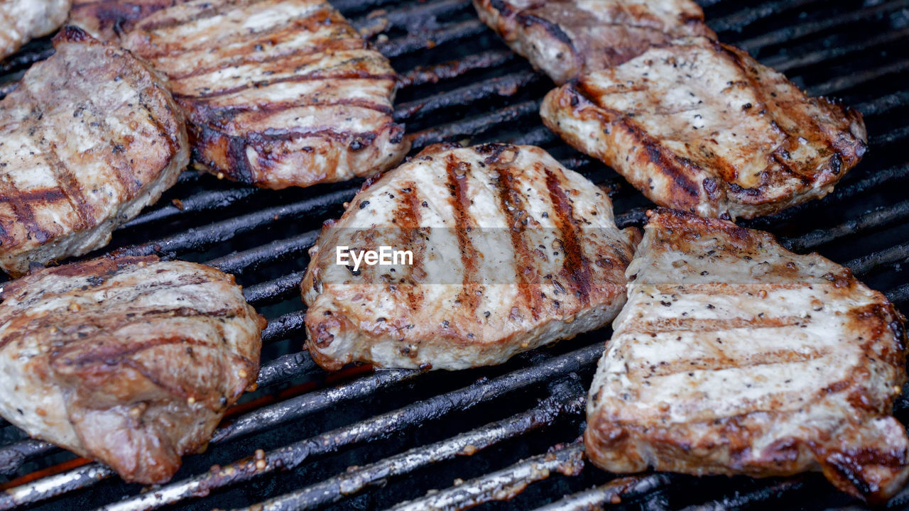 Close-up of grilled meat steak on stainless bbq grill 