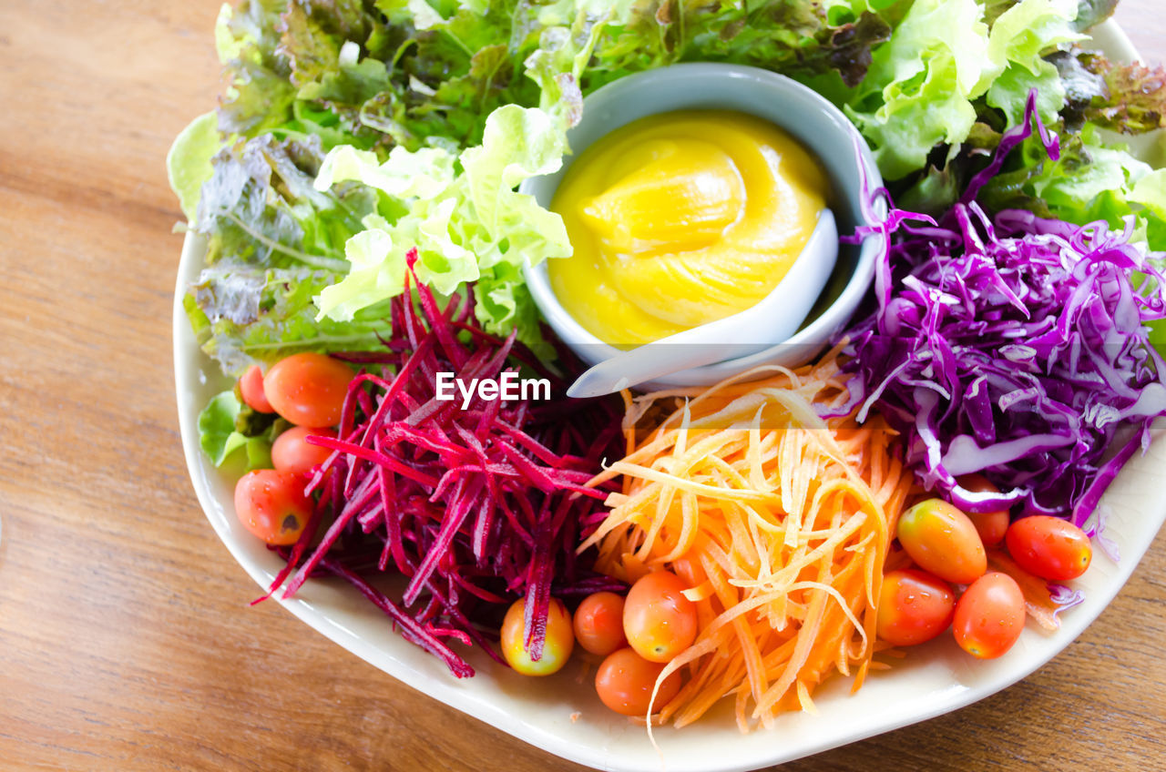 High angle view of salad with dip on table