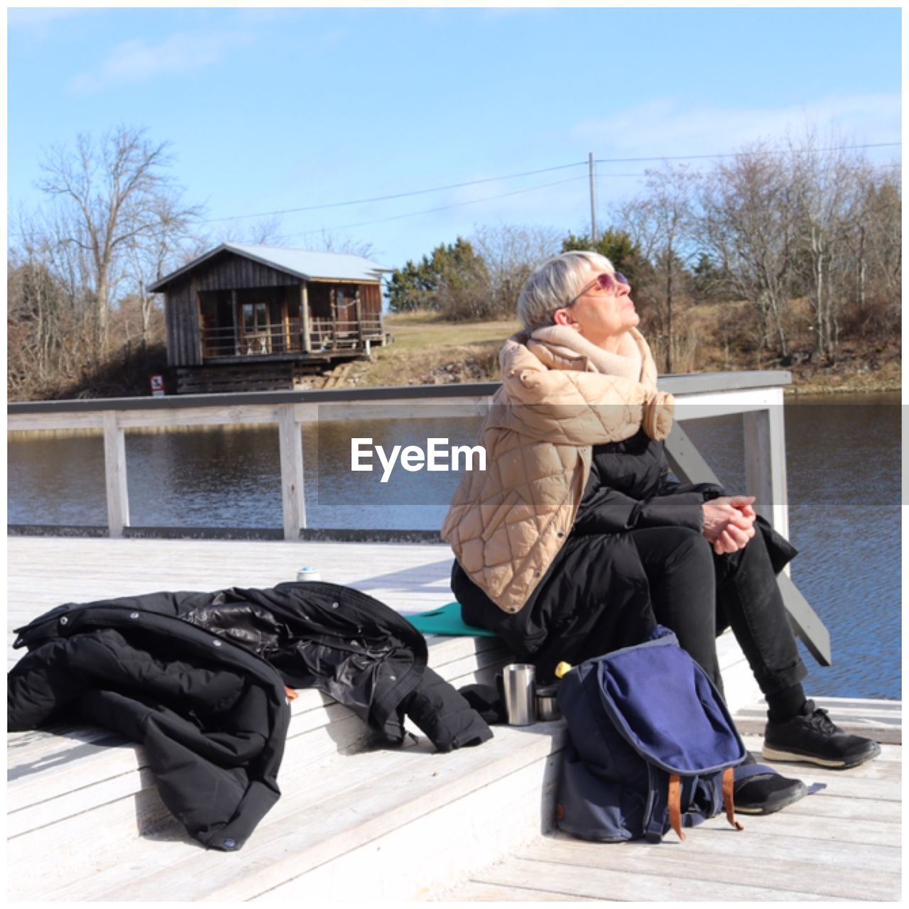 Woman wearing warm clothing sitting outdoors