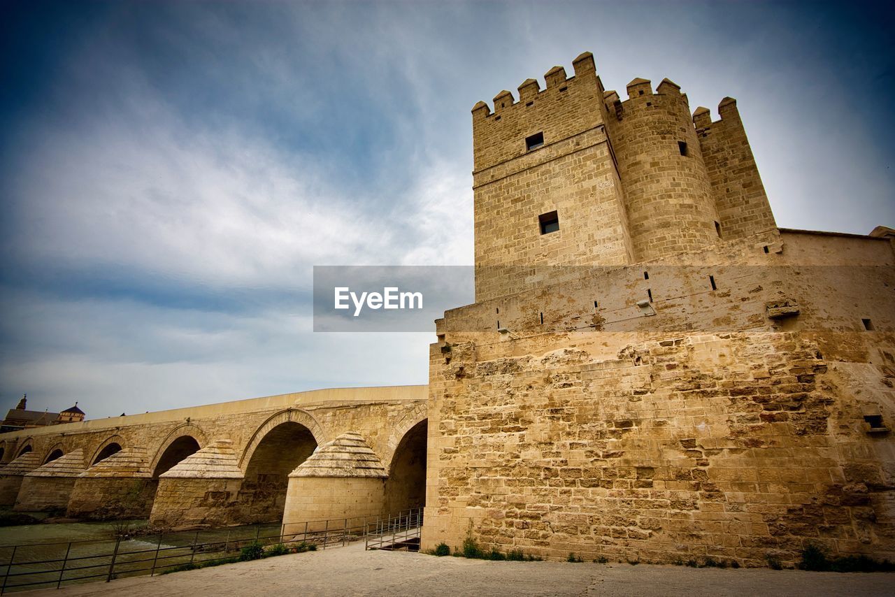 Low angle view of historic building against cloudy sky