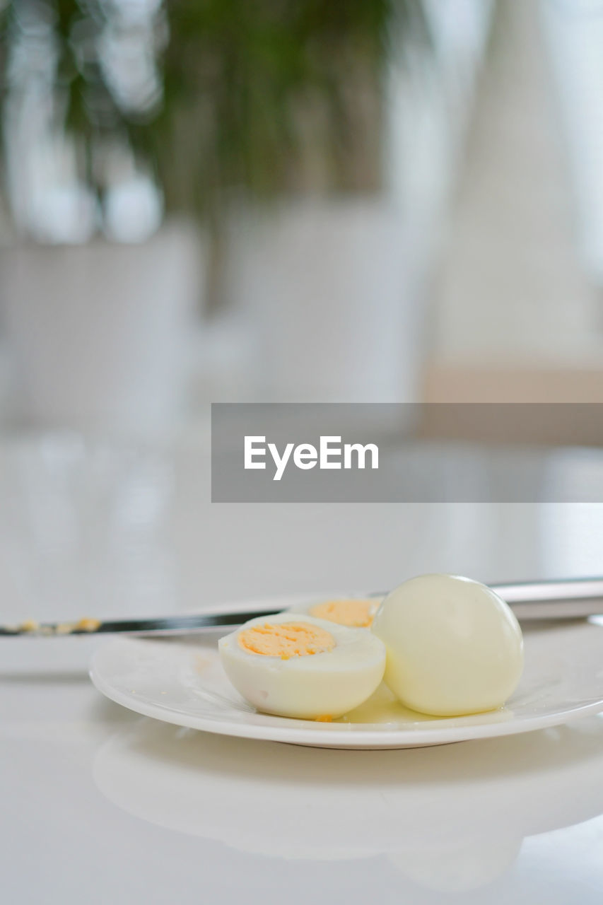 food and drink, food, egg, plate, tableware, healthy eating, kitchen utensil, wellbeing, freshness, eating utensil, egg yolk, no people, table, focus on foreground, white, meal, household equipment, dishware, breakfast, indoors, day, close-up, spoon, serveware