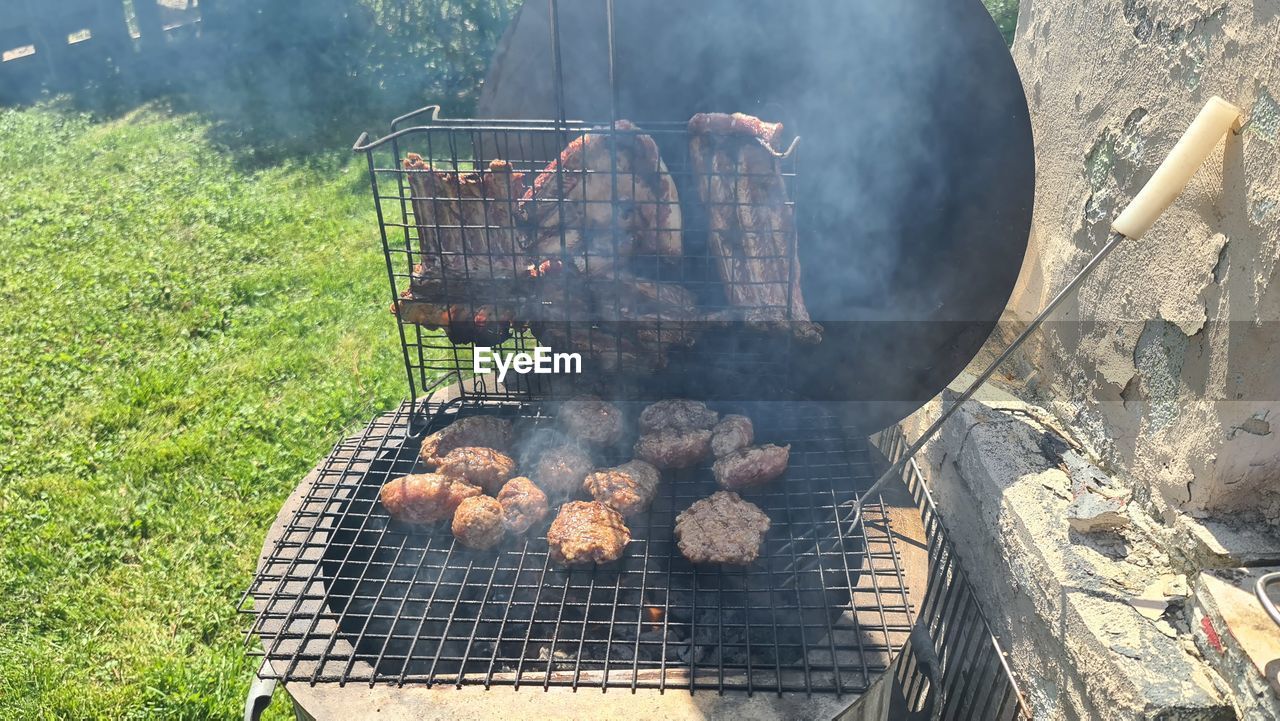 HIGH ANGLE VIEW OF MEAT ON BARBECUE