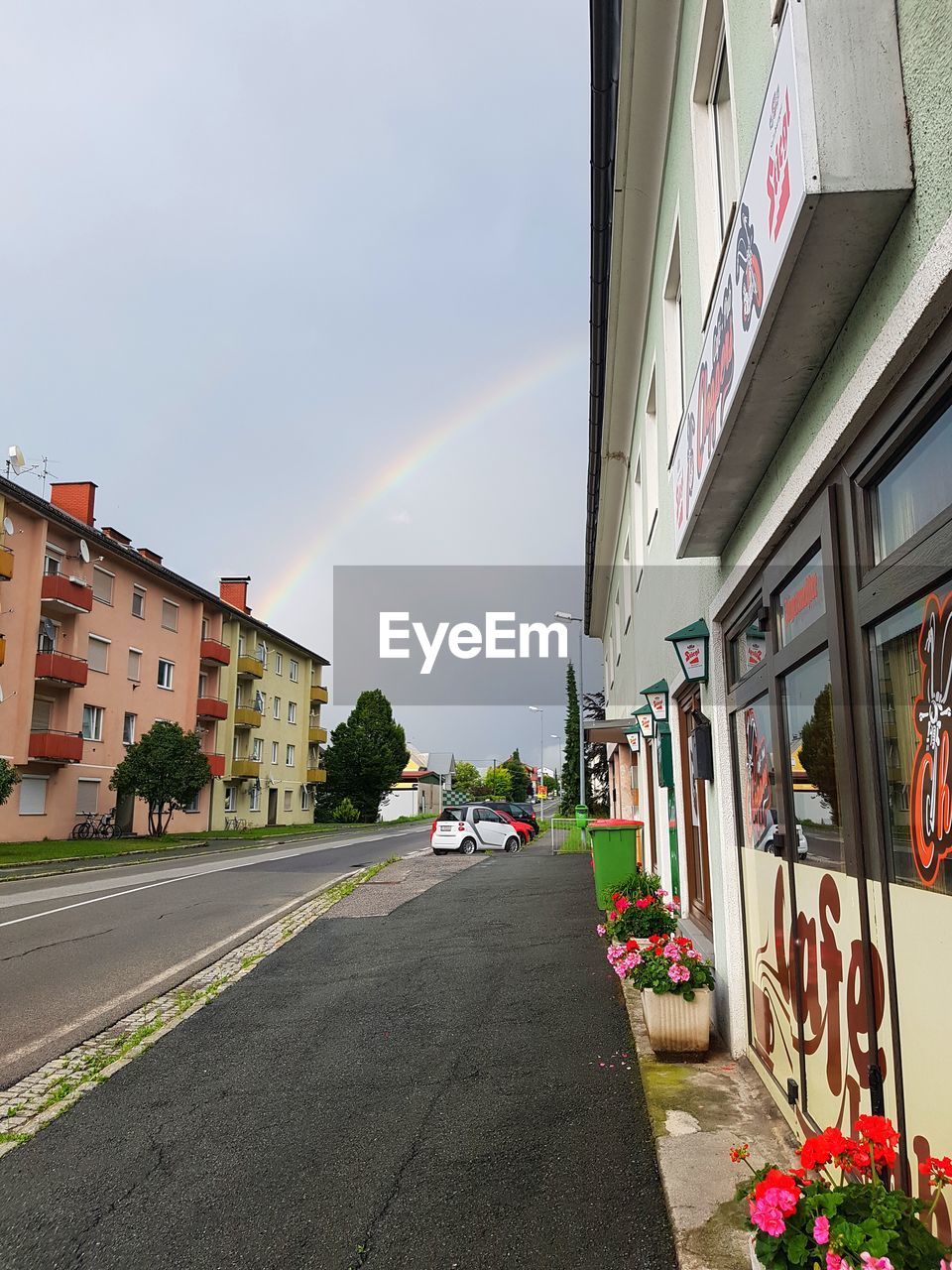 VIEW OF RAINBOW OVER ROAD AGAINST SKY