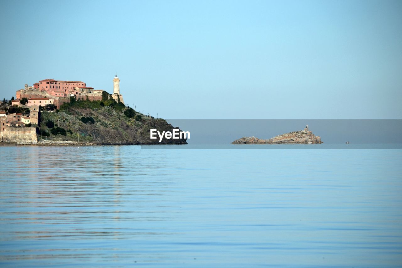 Island of elba by sea against clear sky