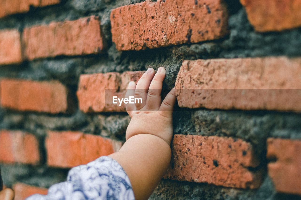 Child hand on wall