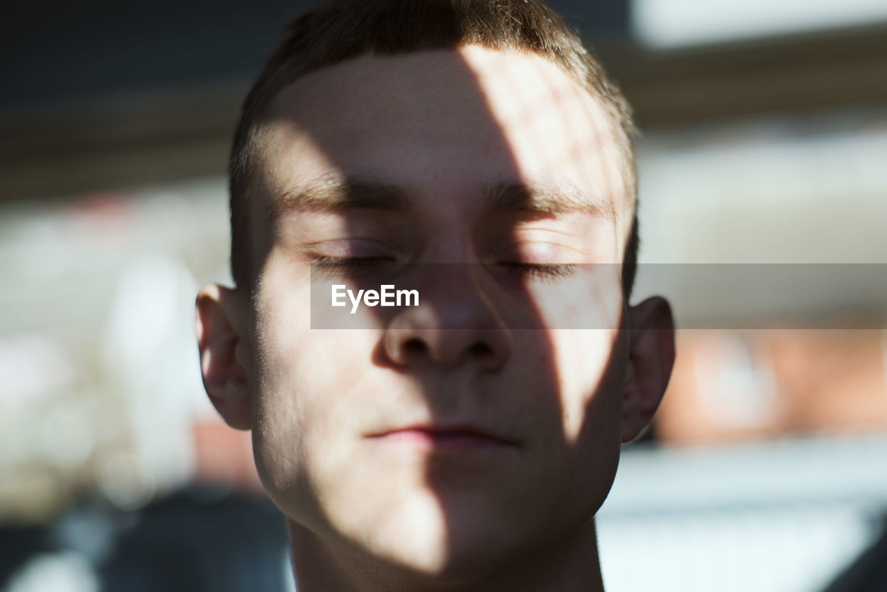 Close-up of young man with eyes closed