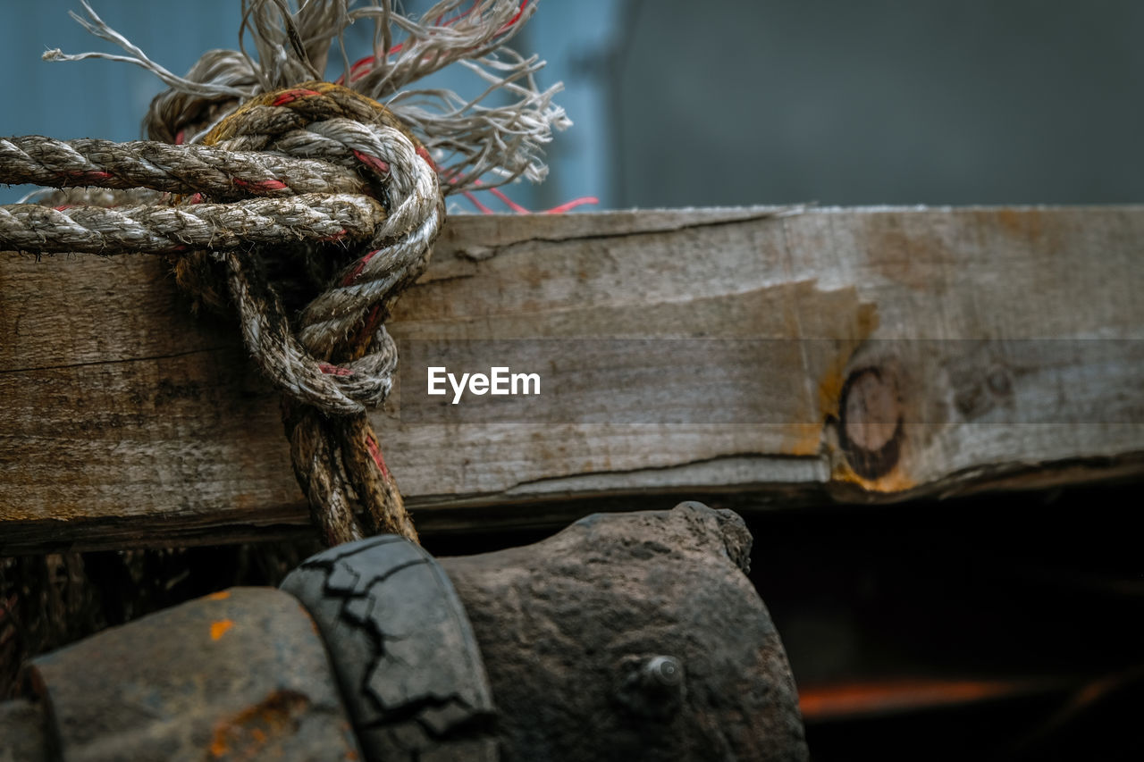 Close-up of rope tied on wood