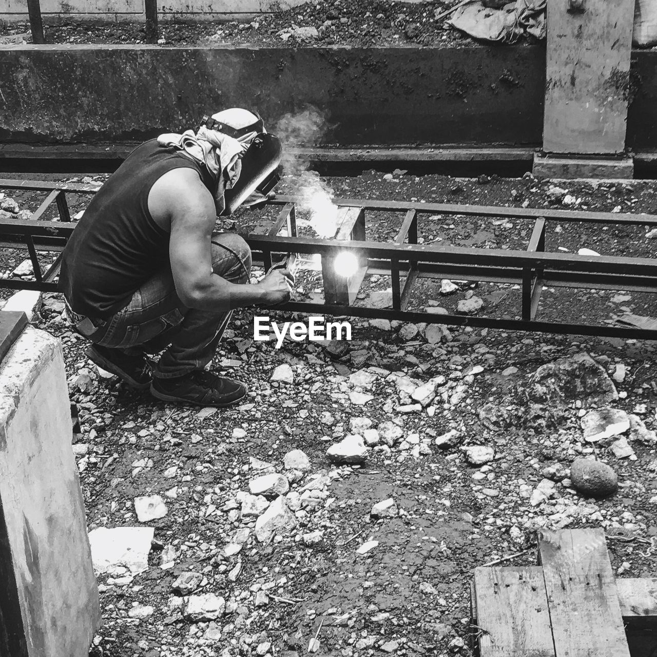 MAN WORKING WITH RETAINING WALL
