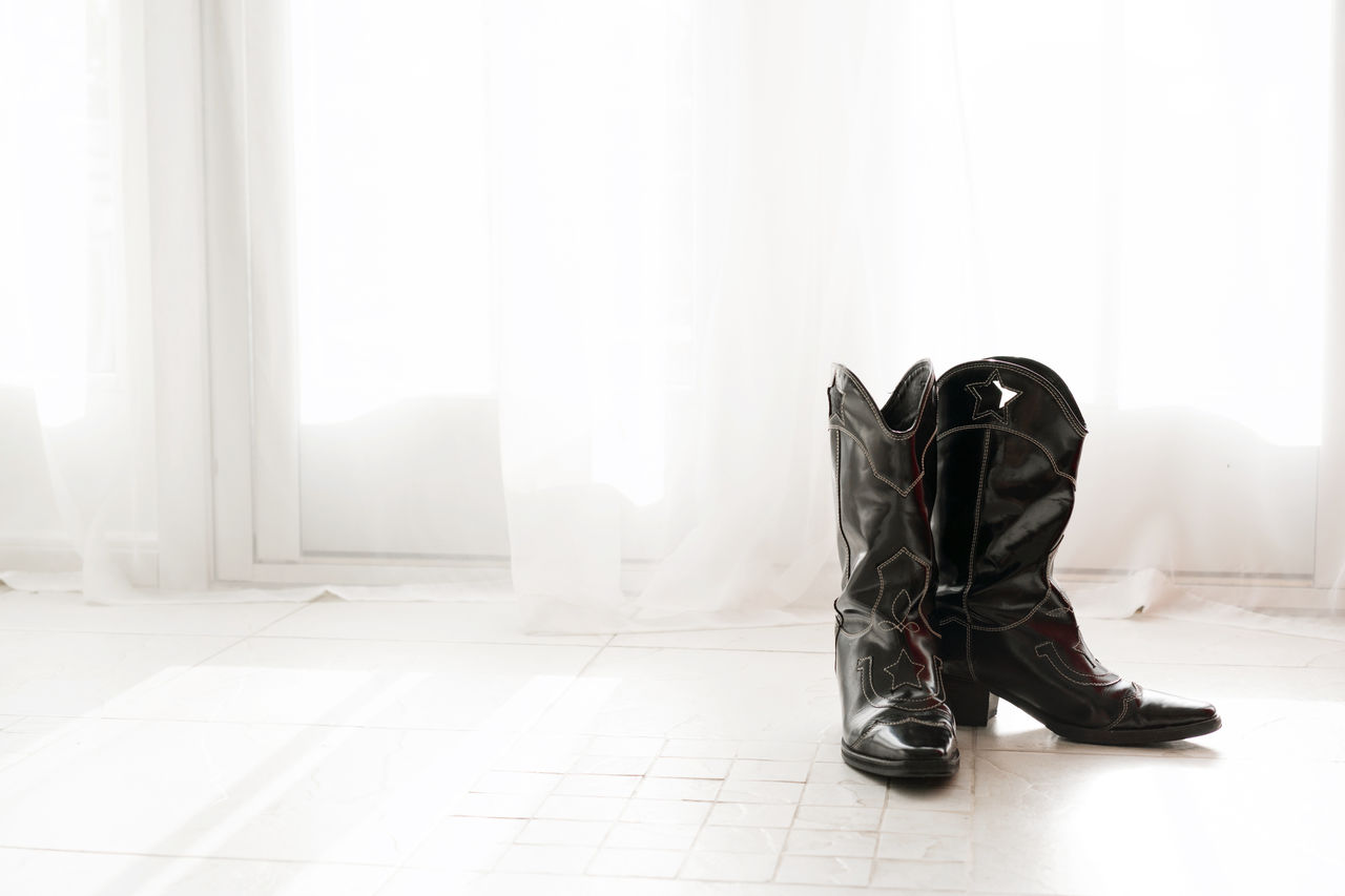 Low section of cowboy boots  shoes at home