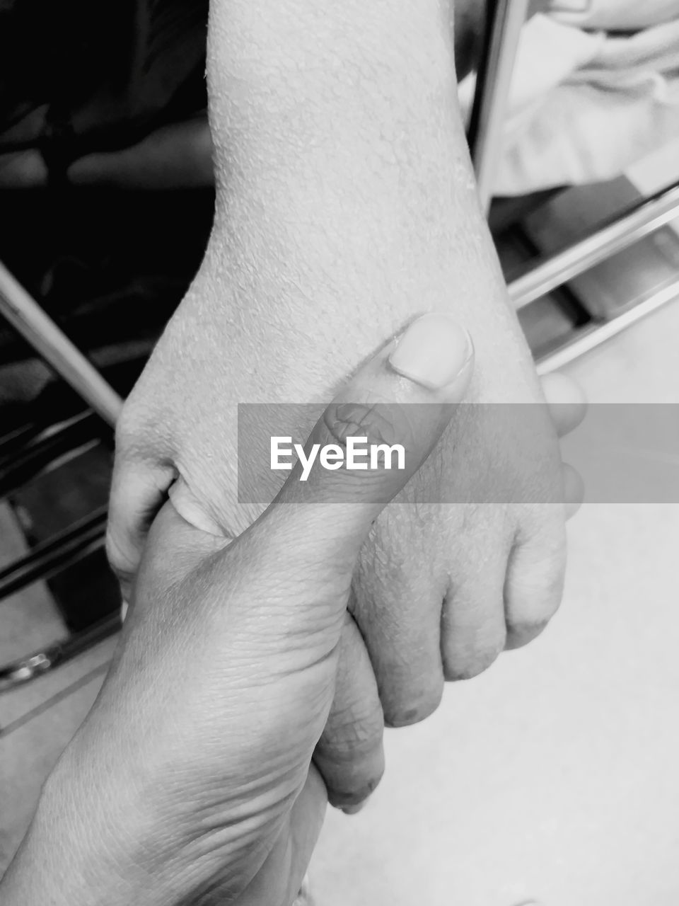 CLOSE-UP OF HANDS HOLDING BABY