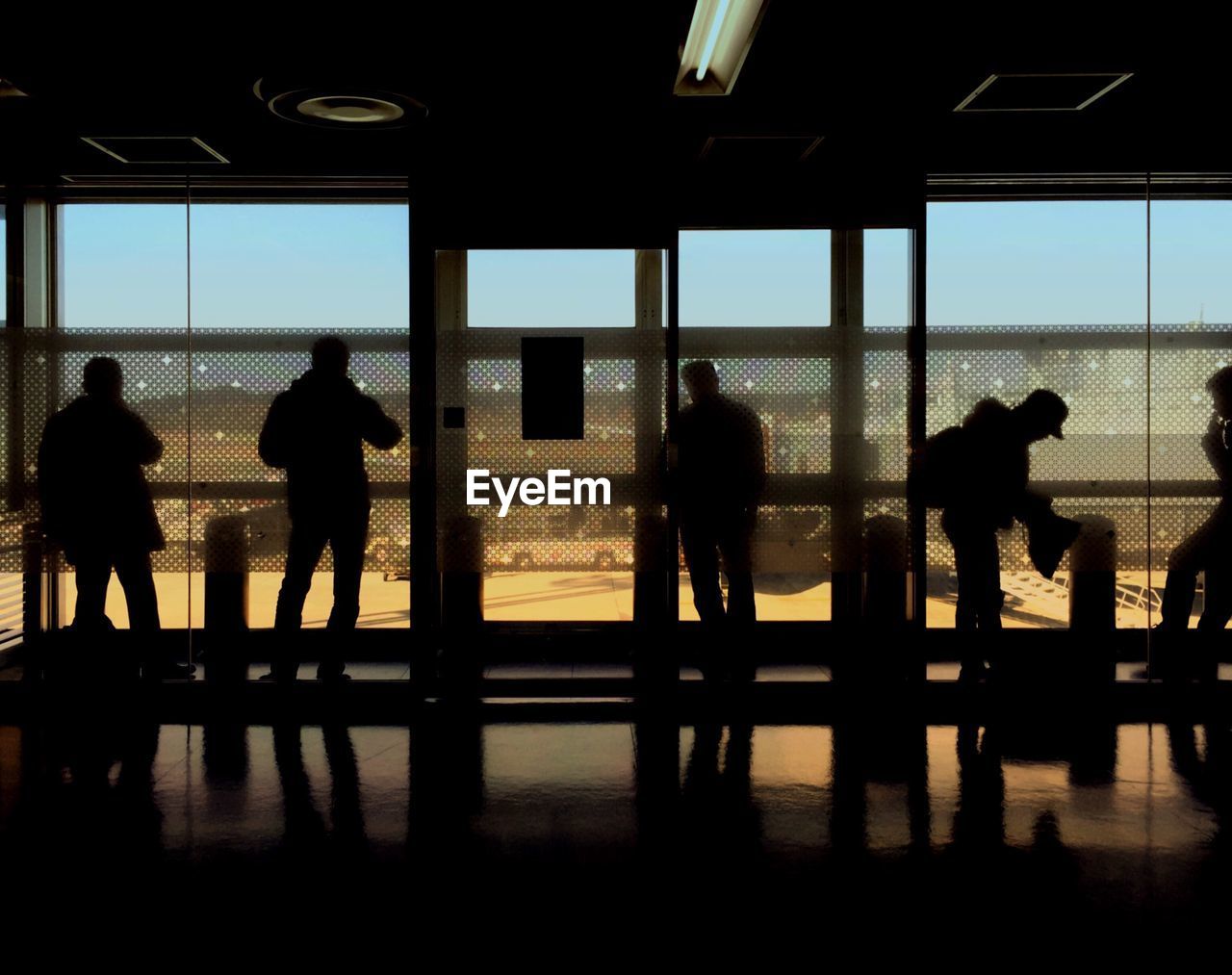 SILHOUETTE PEOPLE IN AIRPORT