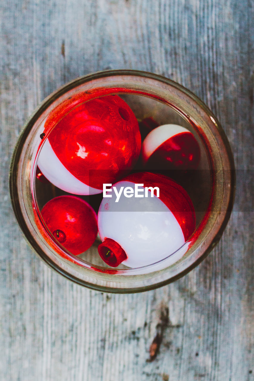 Directly above shot of fishing bobber in bowl on table