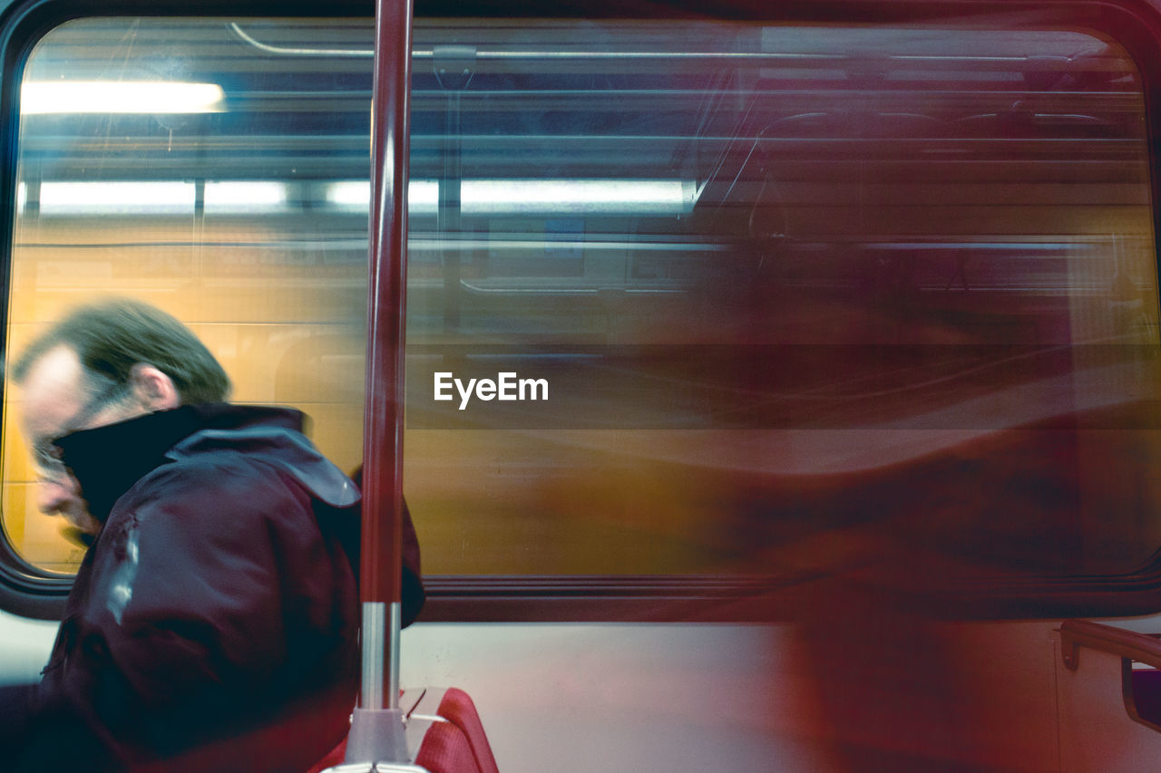 WOMAN SITTING IN TRAIN