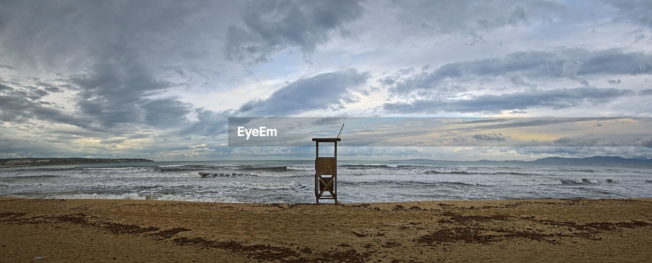 LIFEGUARD HUT ON SHORE AGAINST SKY