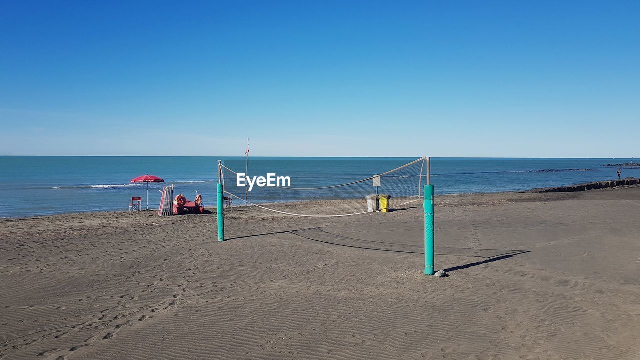 sea, beach, water, land, sky, body of water, ocean, shore, sand, horizon over water, horizon, nature, coast, blue, clear sky, scenics - nature, beauty in nature, vacation, wave, holiday, day, tranquility, trip, sunny, tranquil scene, copy space, travel, outdoors, sunlight, summer, travel destinations, lifeguard hut, bay, lifeguard, sports, idyllic, wind wave