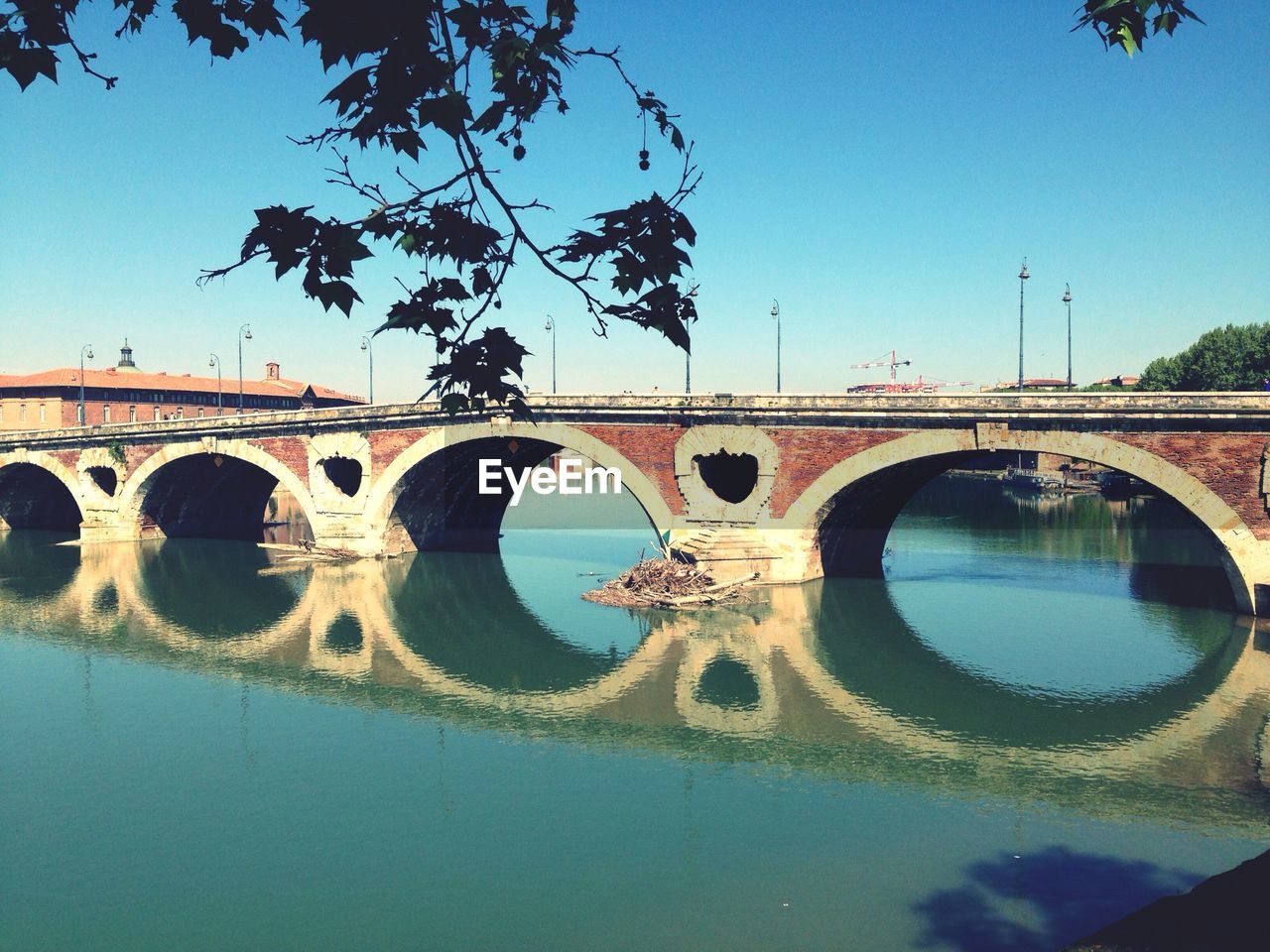 Reflection of arch bridge on river