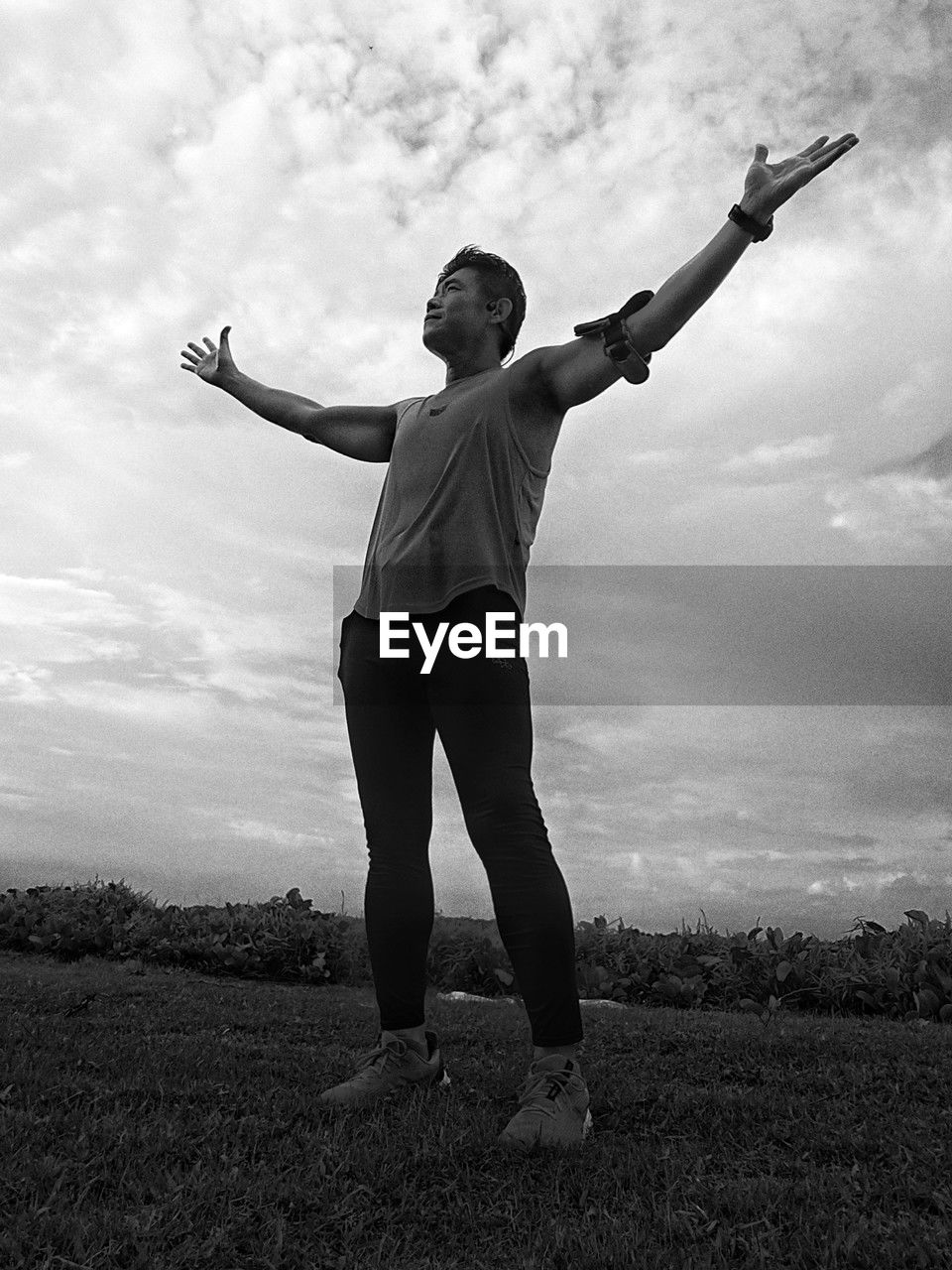 sky, cloud, black and white, one person, black, arm, limb, adult, white, monochrome photography, nature, human limb, full length, arms raised, standing, monochrome, arms outstretched, lifestyles, young adult, success, emotion, landscape, leisure activity, happiness, men, outdoors, environment, field, land, sports, day