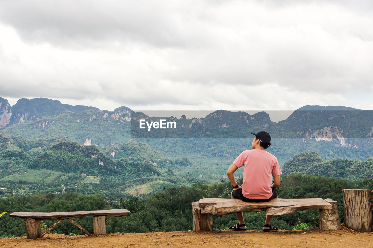 Solo traveller enjoying beautiful nature of hills and during rainy season at doi tapang