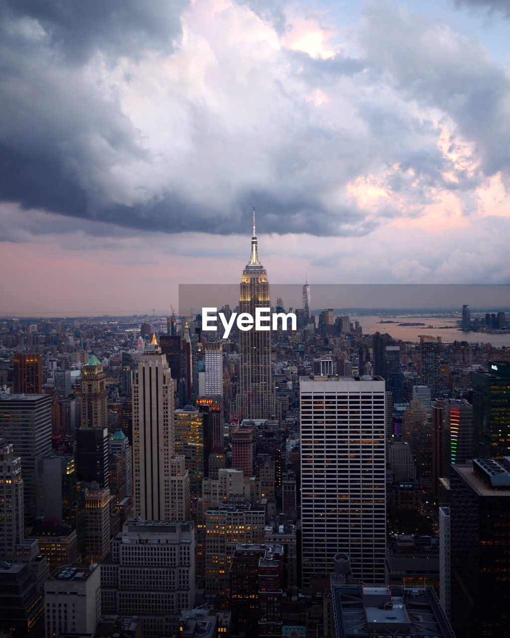 View of cityscape against cloudy sky