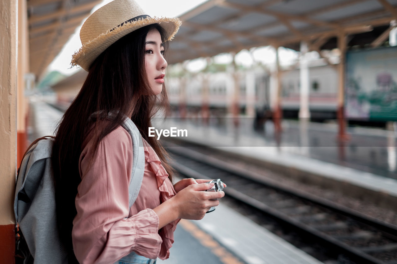 Woman looking away on railroad station platform